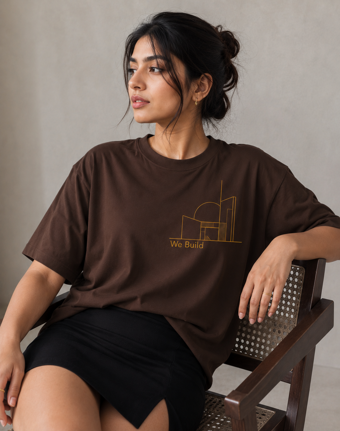 Indian female model wearing We Build oversized chocolate brown T-shirt